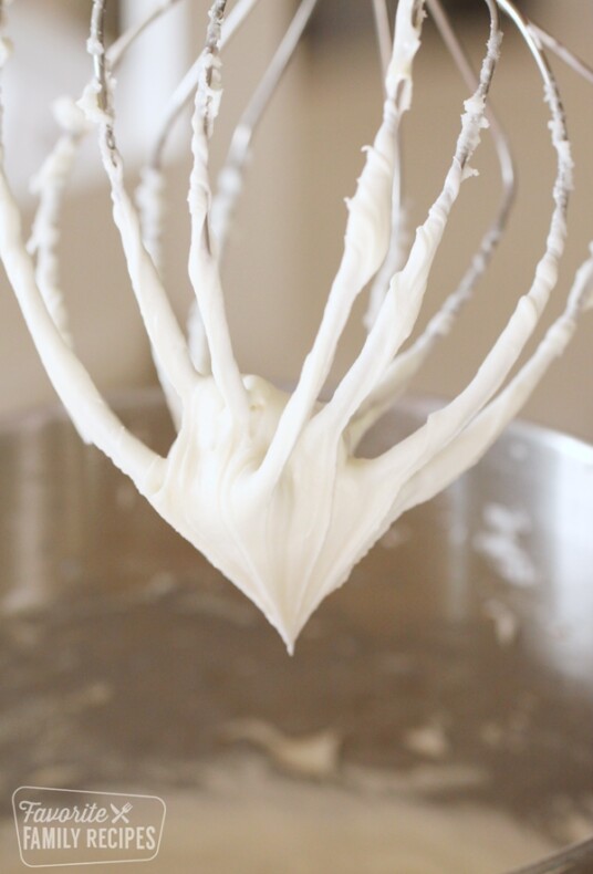 Cream cheese frosting on a whisk