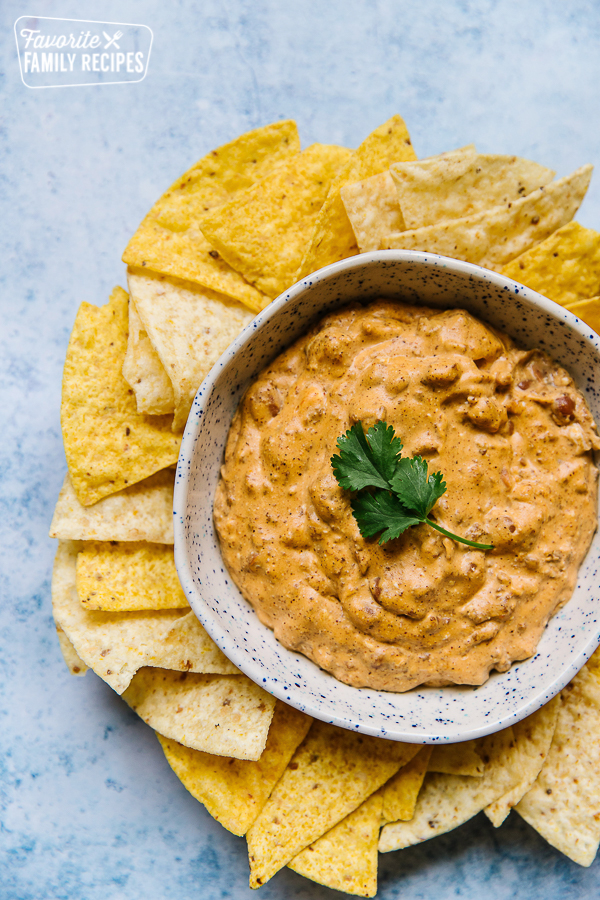 Chili Cheese Dip in a bowl surrounded by tortilla chips
