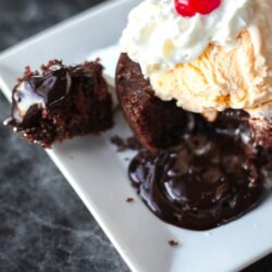Easy Molten Chocolate Cake with melty hot fudge coming out the center