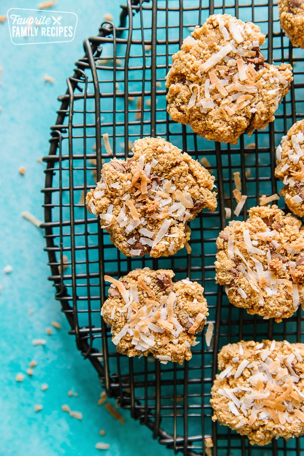 Graham Cracker Cookies with Coconut on a round cooling rack with a teal background.