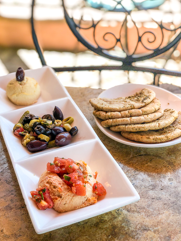 Hummus and imported olives with cornichons and zaatar pita bread at Spice Road Table in Epcot's World Showcase
