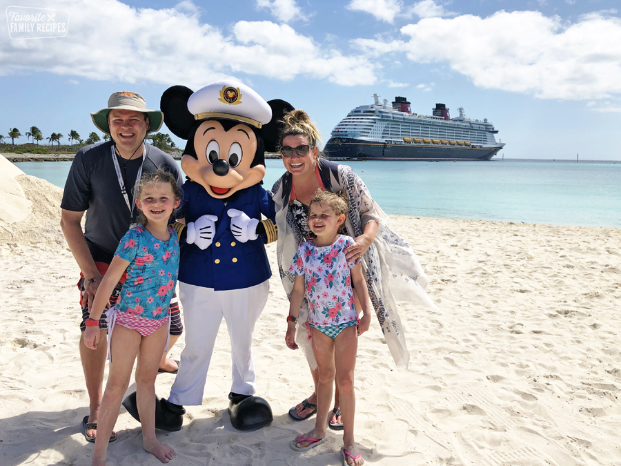 Erica and her family with Mickey in front of their Disney cruise. 