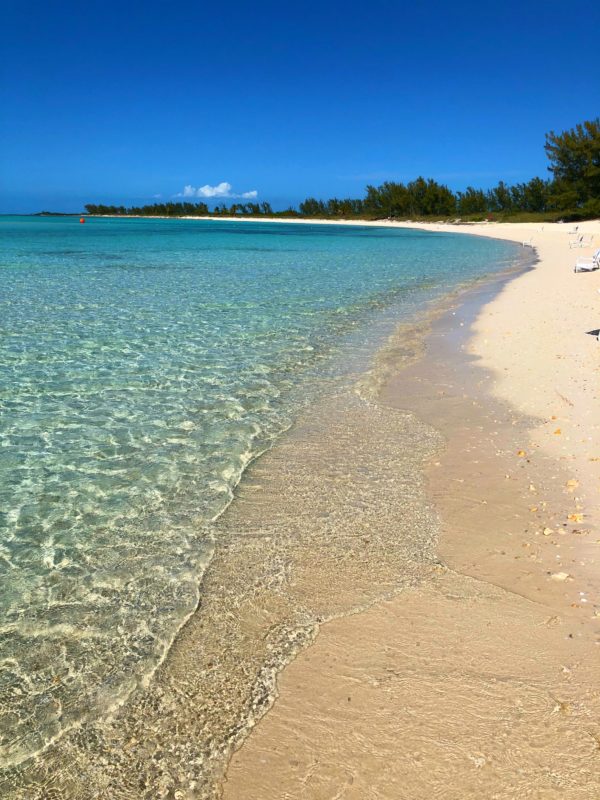 Photo of the beach with water coming up. 