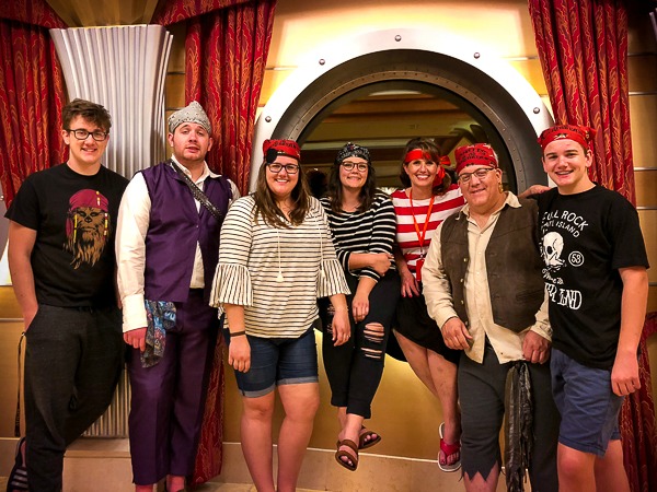 Our top "insider" tips for everything you need to know about Pirate Night on a Disney Cruise. We will tell you all the ways to make the most out of Pirate Night on your next magical Disney Cruise vacation. Echo and her family dressed in pirate costumes for the pirate night on the cruise.