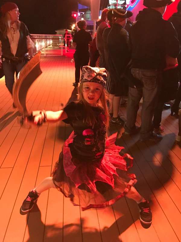 Piper in her pirate costume holding a knife on the cruise. 