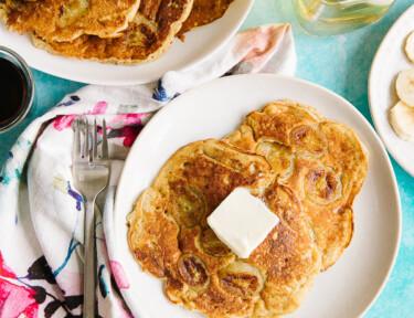 Banana pancakes on a plate with butter on top