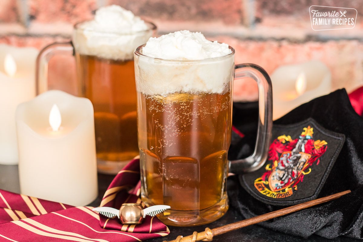 Two glass mugs of Butterbeer 