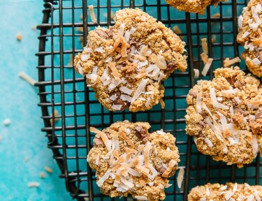 Graham Cracker Cookies with Coconut on a round cooling rack with a teal background
