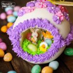 Panoramic Easter Eggs - a sugar egg decorated with frosting with miniature bunnies, chicks, flowers, and jelly beans in the center