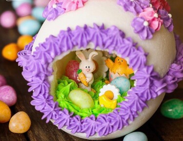 Panoramic Easter Eggs - a sugar egg decorated with frosting with miniature bunnies, chicks, flowers, and jelly beans in the center