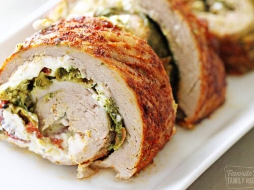 Rolled stuffed pork tenderloin slices on a plate