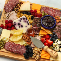 charcuterie board appetizer with meats, cheeses, and vegetables