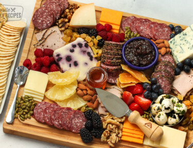 charcuterie board appetizer with meats, cheeses, and vegetables