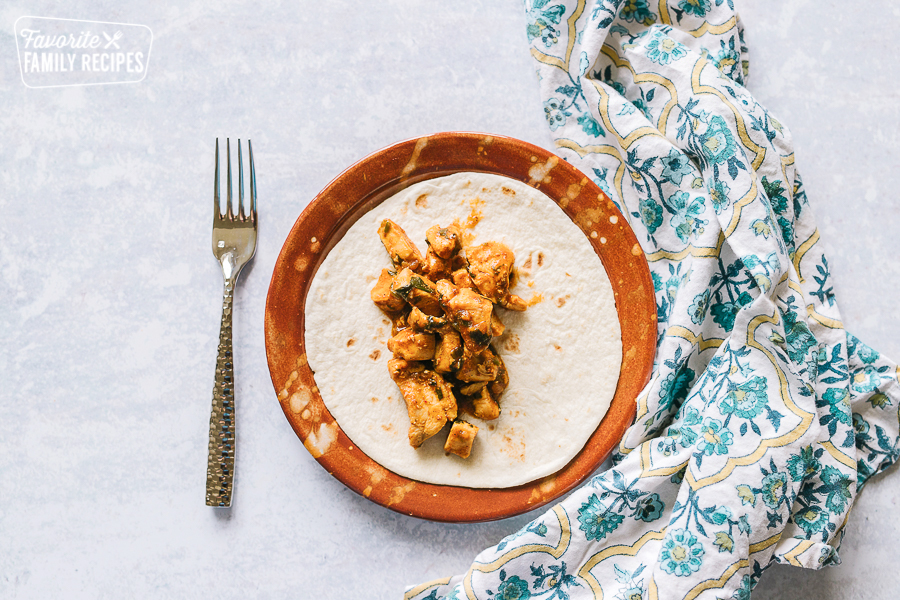 Chicken Taco on a plate with no toppings added yet.