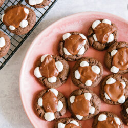 Chocolate Marshmallow Cookies on a pink plate with a cooling rack to the side