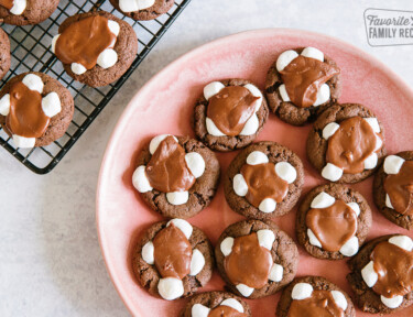 Chocolate Marshmallow Cookies on a pink plate with a cooling rack to the side