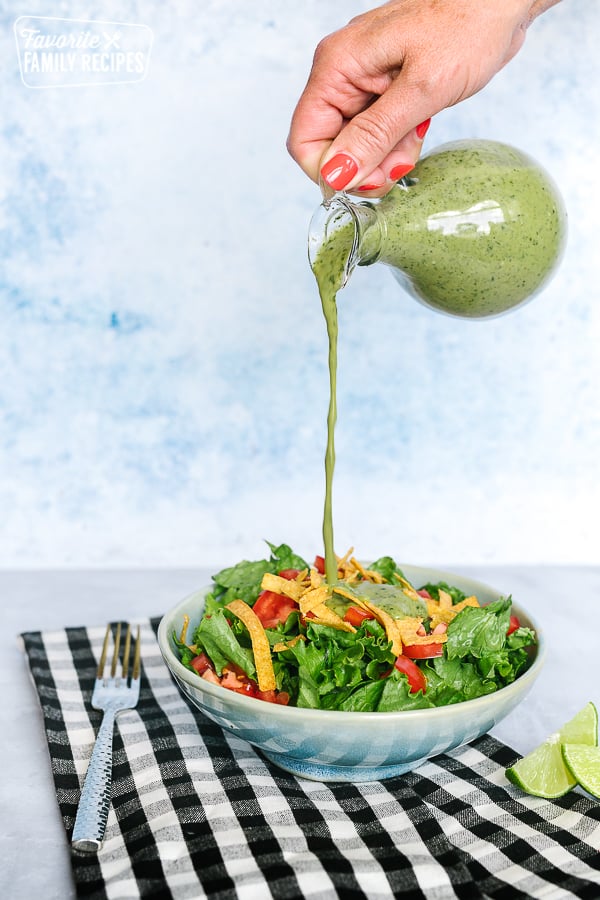 Cilantro Lime Dressing being poured over a salad