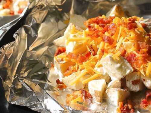 Grilled Foil Ranch Potatoes topped with bacon and cheese.