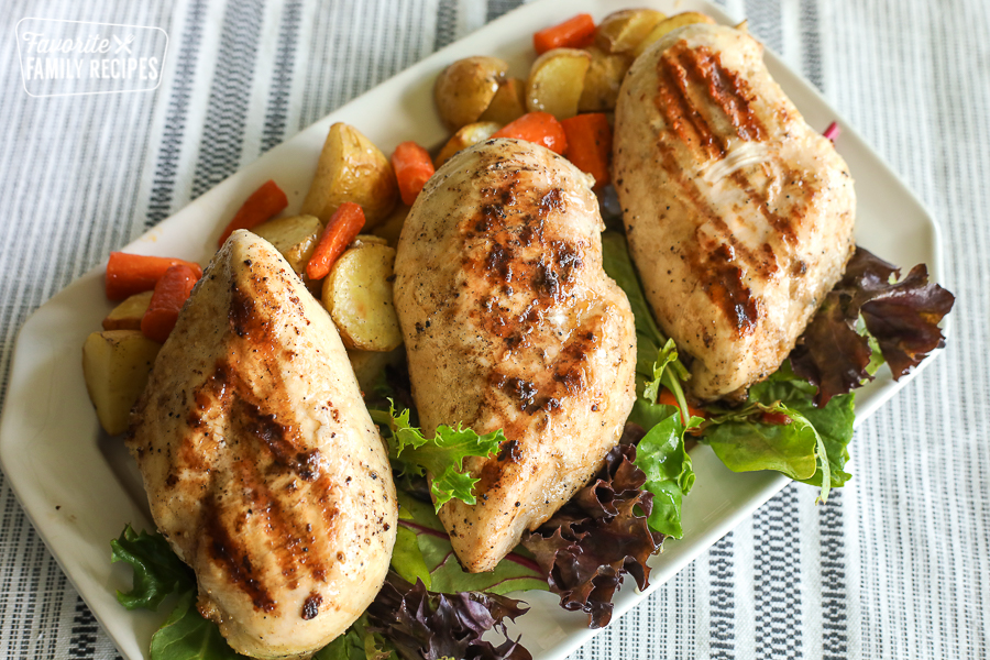 Grilled Lemon Pepper Chicken on a tray with vegetables