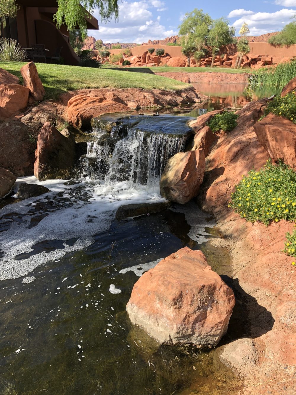 A waterfall on a golf course. 