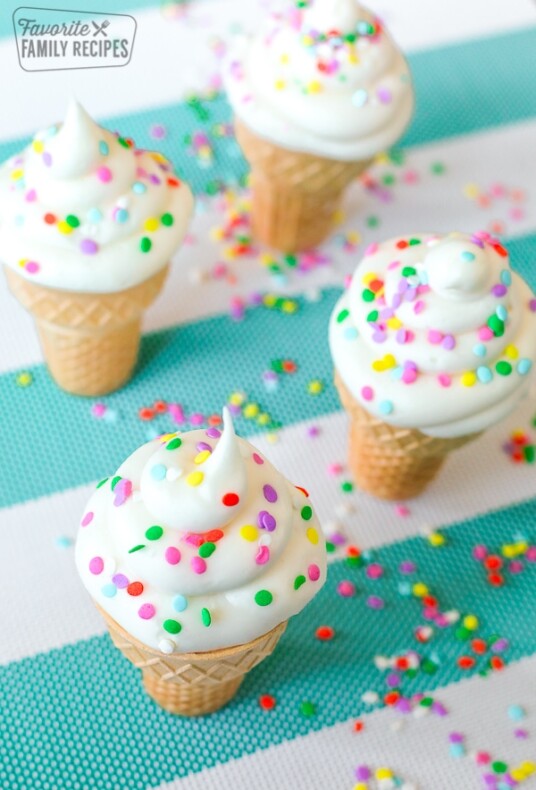 Four Ice Cream Cone Cupcakes on a teal and white striped tablecloth