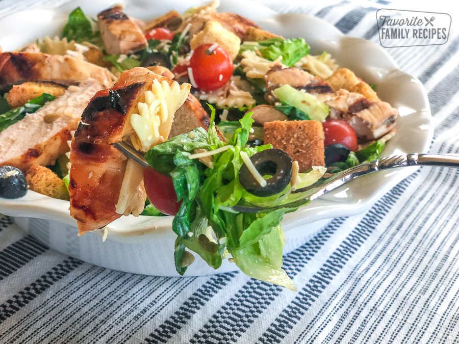 a forkful of chicken caesar pasta salad