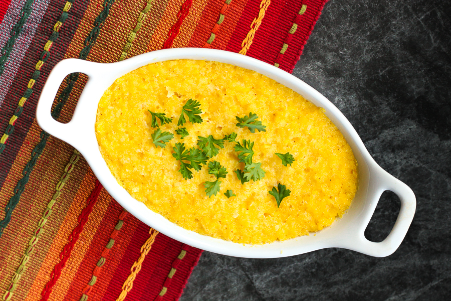 Sweet Corn Cake also known as Corn Tamalitos in a casserole dish sprinkled with cilantro 