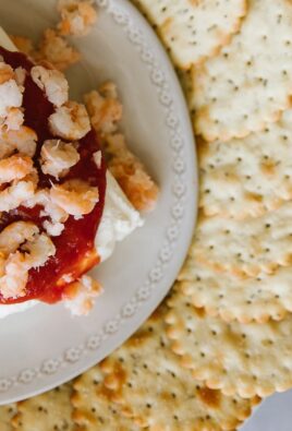 Cream Cheese Shrimp Dip on a white plate surrounded by crackers