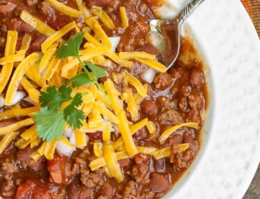 Chili in a bowl with shredded cheese on top