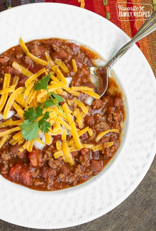 Chili in a bowl with shredded cheese on top