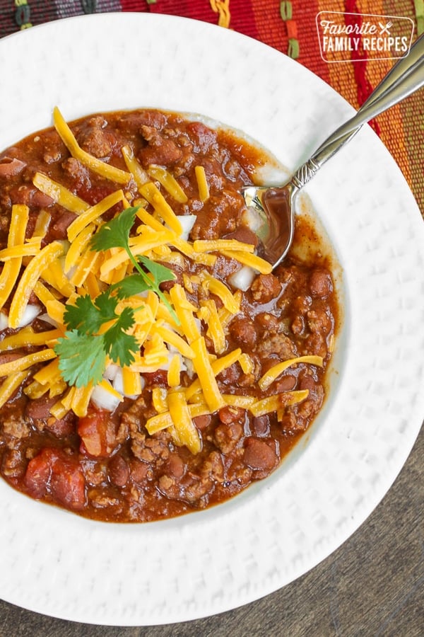 Chili in a bowl with shredded cheese on top