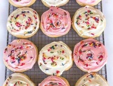 A tray of pink and white frosted Grandma's soft sugar cookies