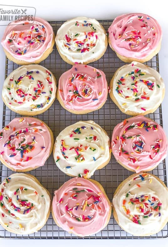A tray of pink and white frosted Grandma's soft sugar cookies