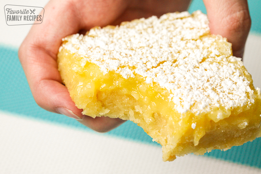A Lemon Bar with a bite taken out of the middle