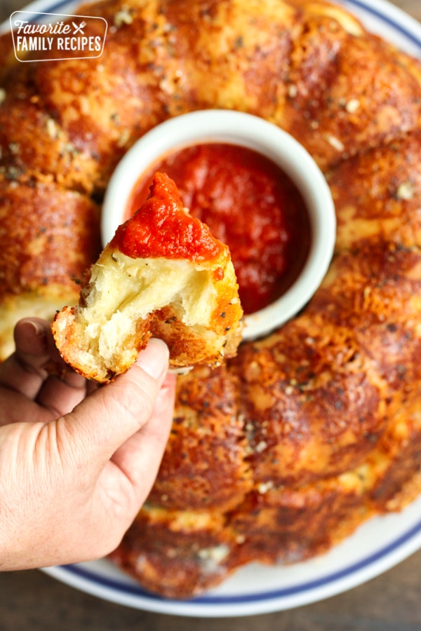 Parmesan pull apart bread being dipped in marinara sauce