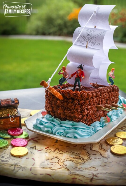 Pirate ship birthday cake on a treasure map.