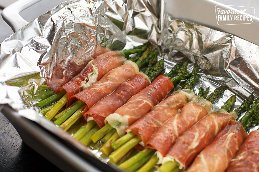 A tray of prosciutto wrapped asparagus appetizer