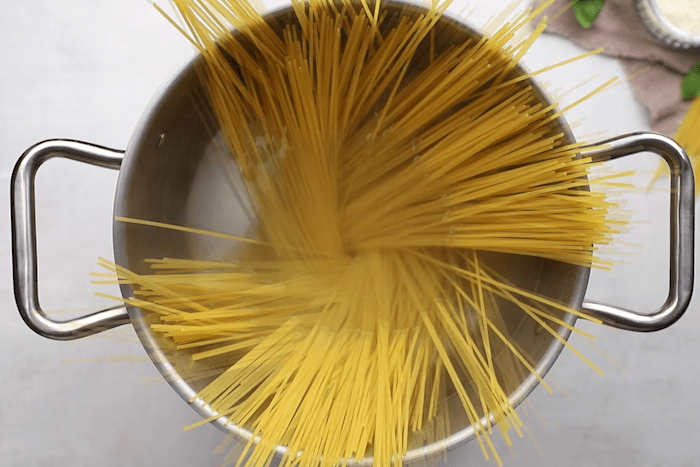 Spaghetti noodles boiling in a pot for The Old Spaghetti Factory's Mizithra Pasta.