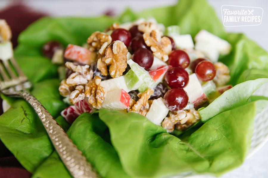 Side view of a Waldorf salad with apples, grapes, celery, and walnuts