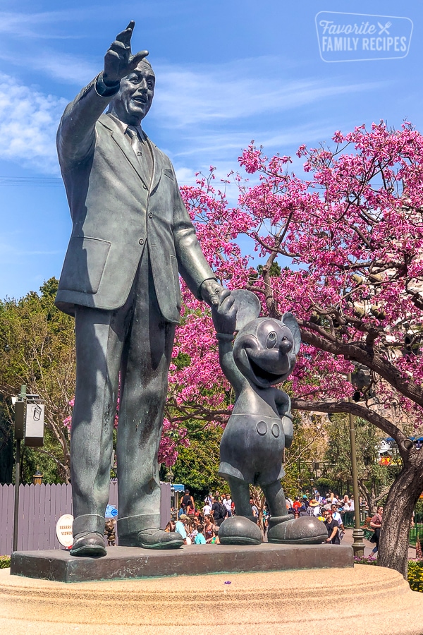 Walt Disney and Mickey Mouse statue holding hands. 