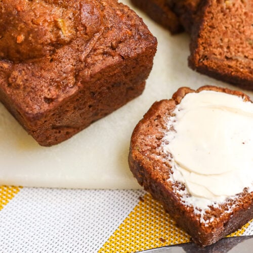 A slice of gluten free zucchini bread on a cutting board