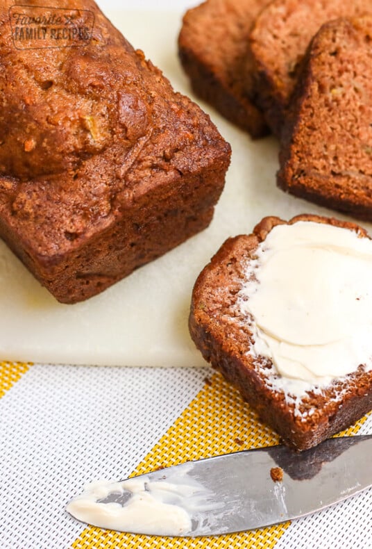 A slice of gluten free zucchini bread on a cutting board