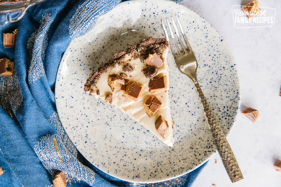 A slice of peanut butter pie with Reese's peanut butter cups on top.