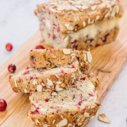 Cranberry bread with slices on a board