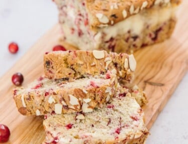 Cranberry bread with slices on a board