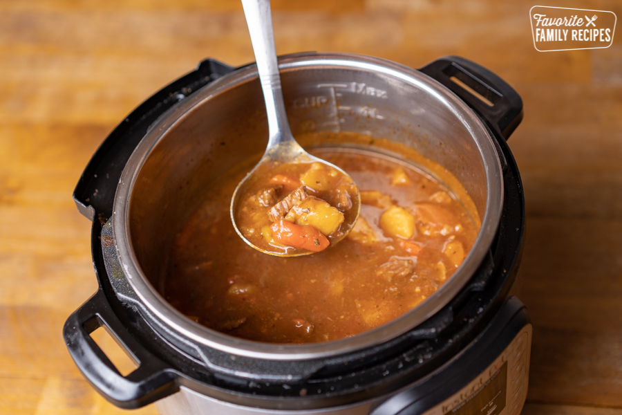 A ladle scooping beef stew out of an instant pot
