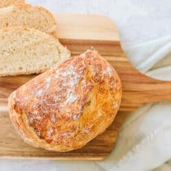 Dutch oven bread on a wood cutting board