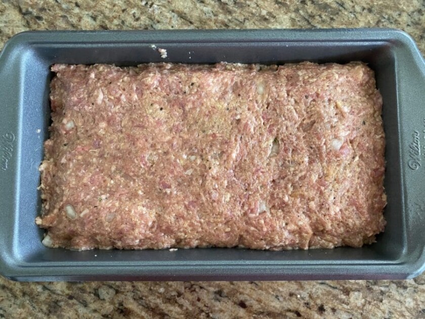 Raw meatloaf in a loaf pan