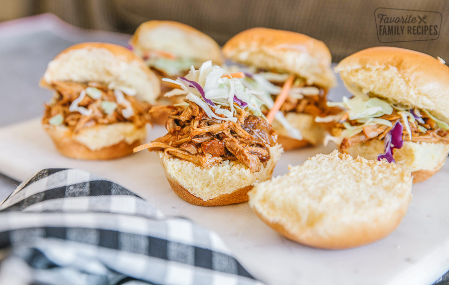 Pulled pork sandwiches on a white slate. 