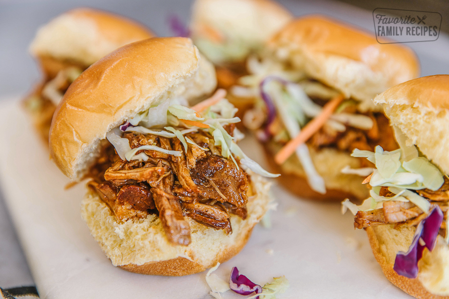 A tray of pulled pork sliders made with pulled pork and coleslaw.